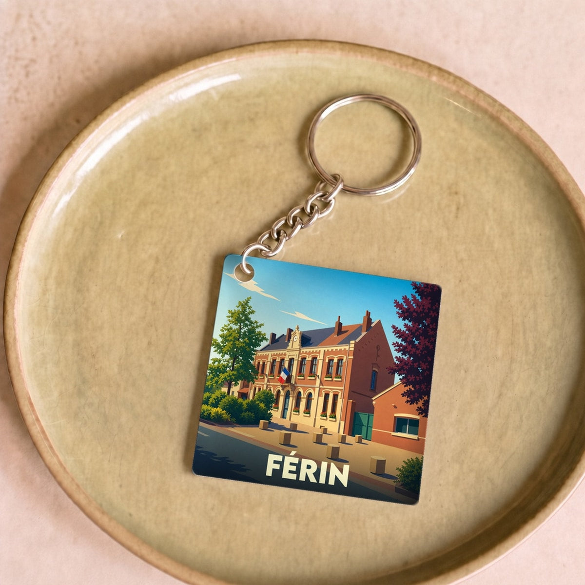 Porte-clés souvenir de la ville de Férin avec une illustration stylisée.