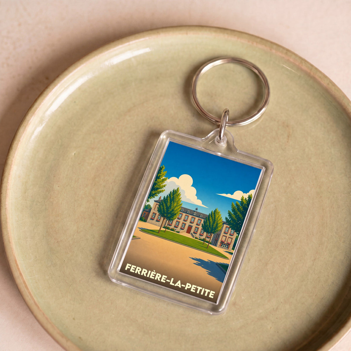Porte-clés souvenir de la ville de Ferrière-la-Petite avec une illustration stylisée.
