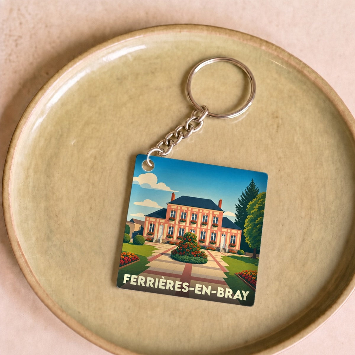 Porte-clés souvenir de la ville de Ferrières-en-Bray avec une illustration stylisée de sa mairie.