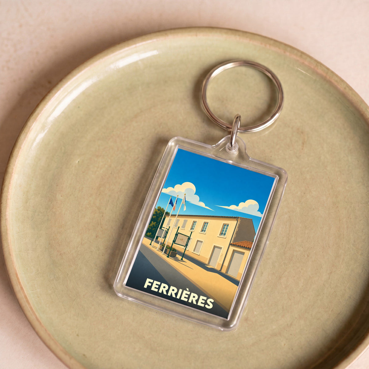 Porte-clés souvenir de la ville de Ferrières avec une illustration stylisée.