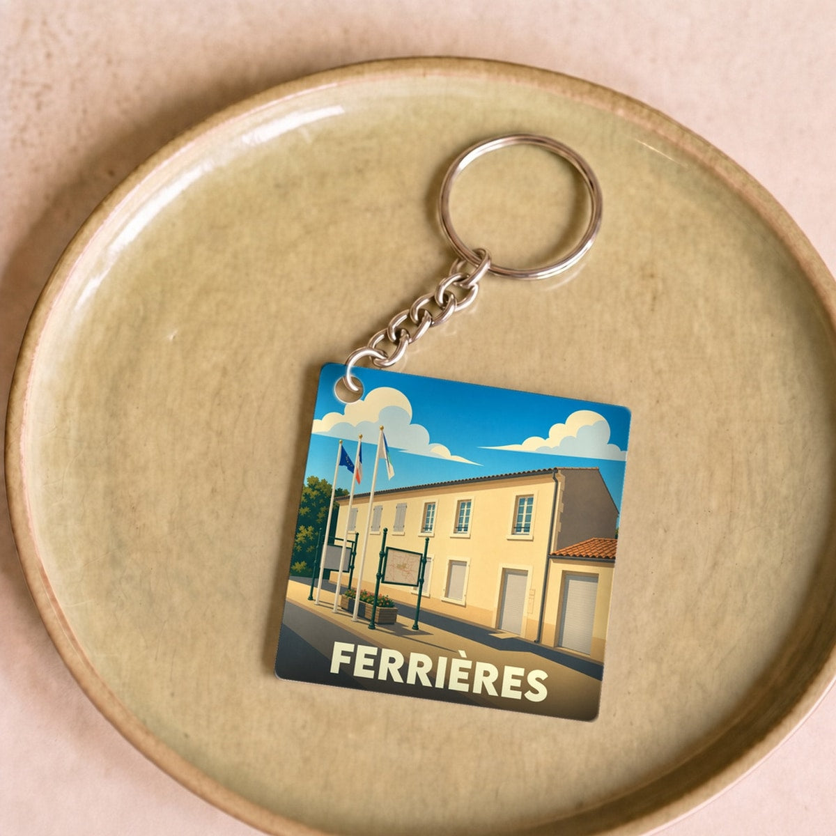 Porte-clés souvenir de la ville de Ferrières avec une illustration stylisée.