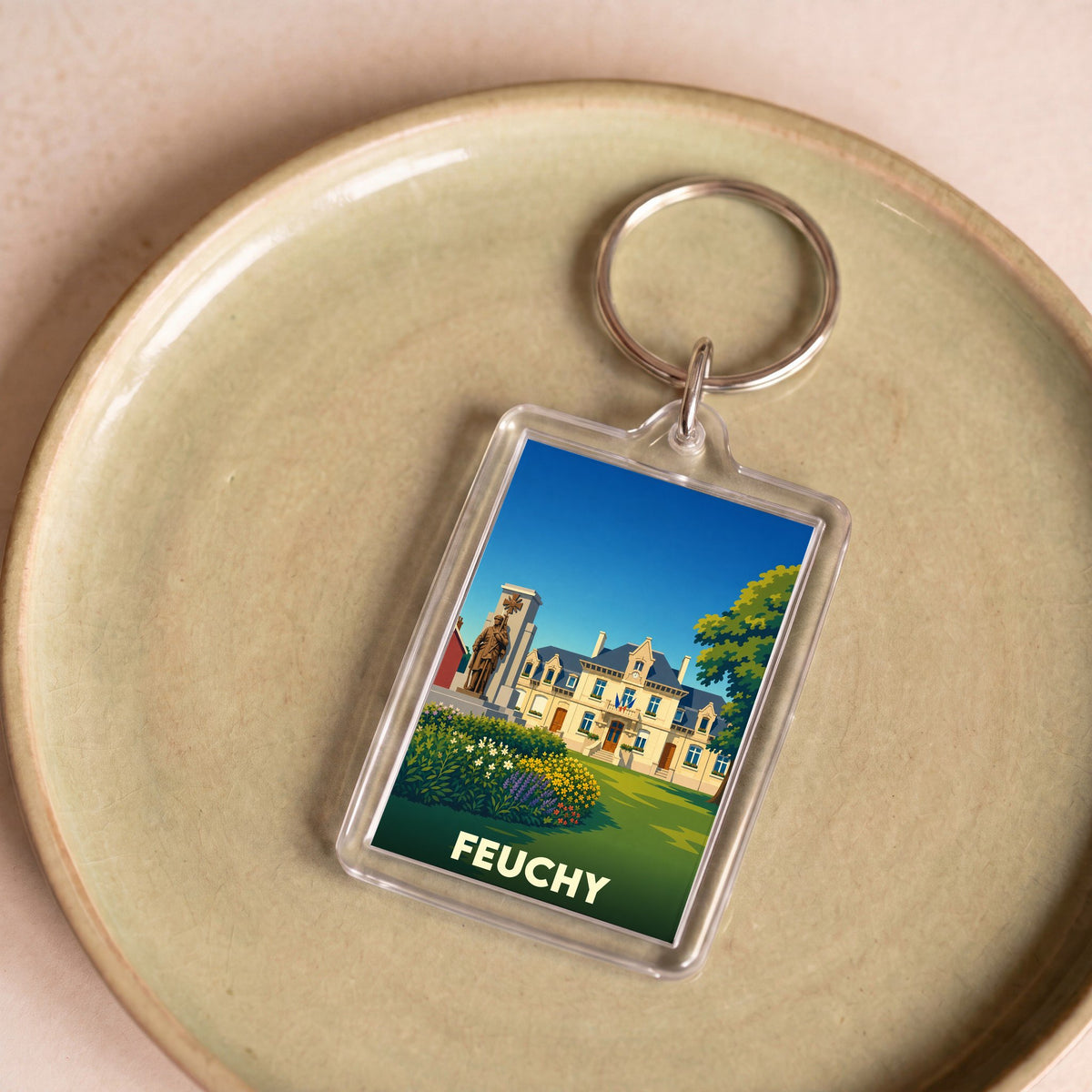 Porte-clés souvenir de la ville de Feuchy avec une illustration stylisée.