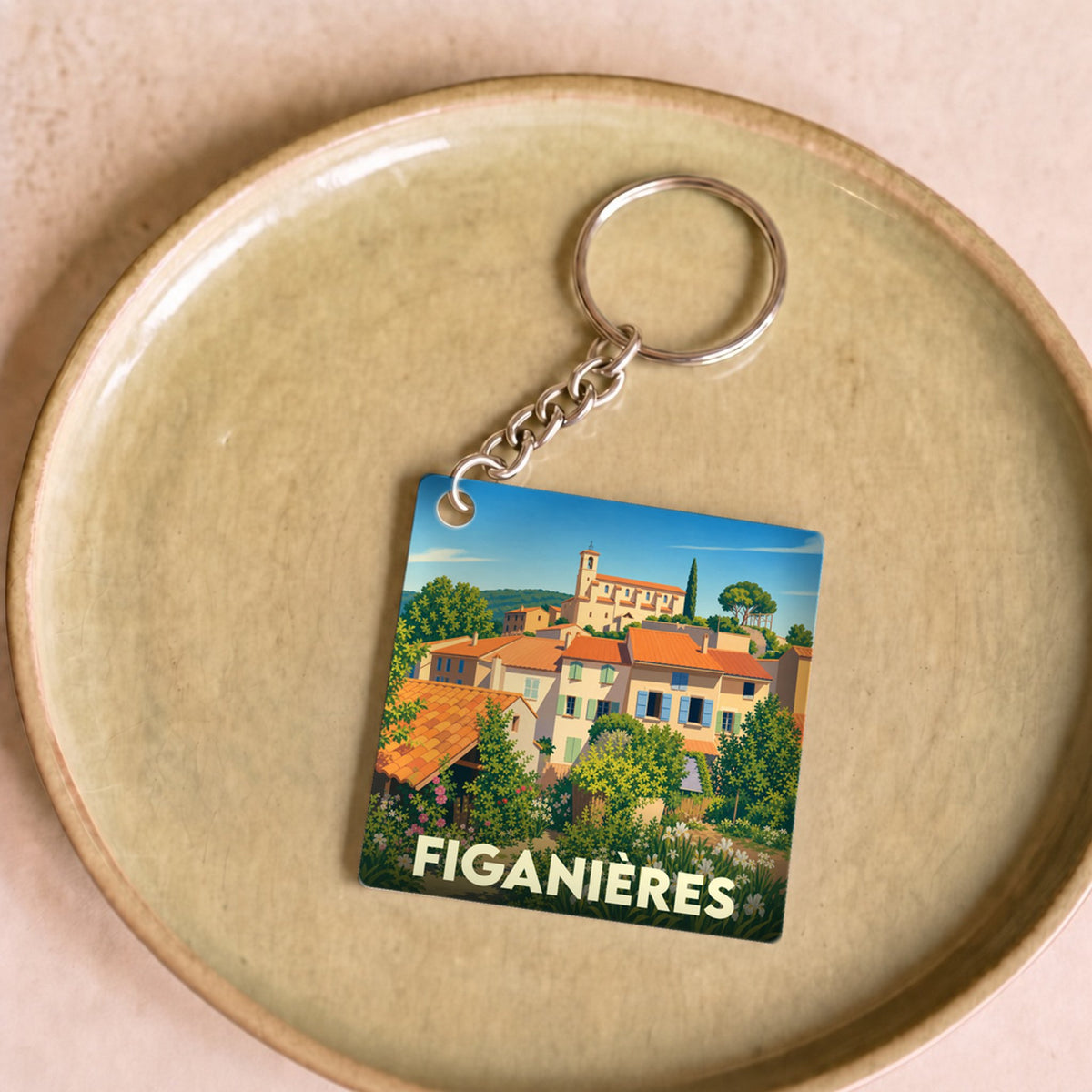 Porte-clés souvenir de la ville de Figanières avec une illustration colorée de style vintage.