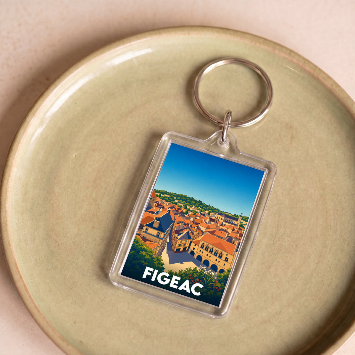 Porte-clés souvenir de la ville de Figeac avec une illustration stylisée de ses toits.