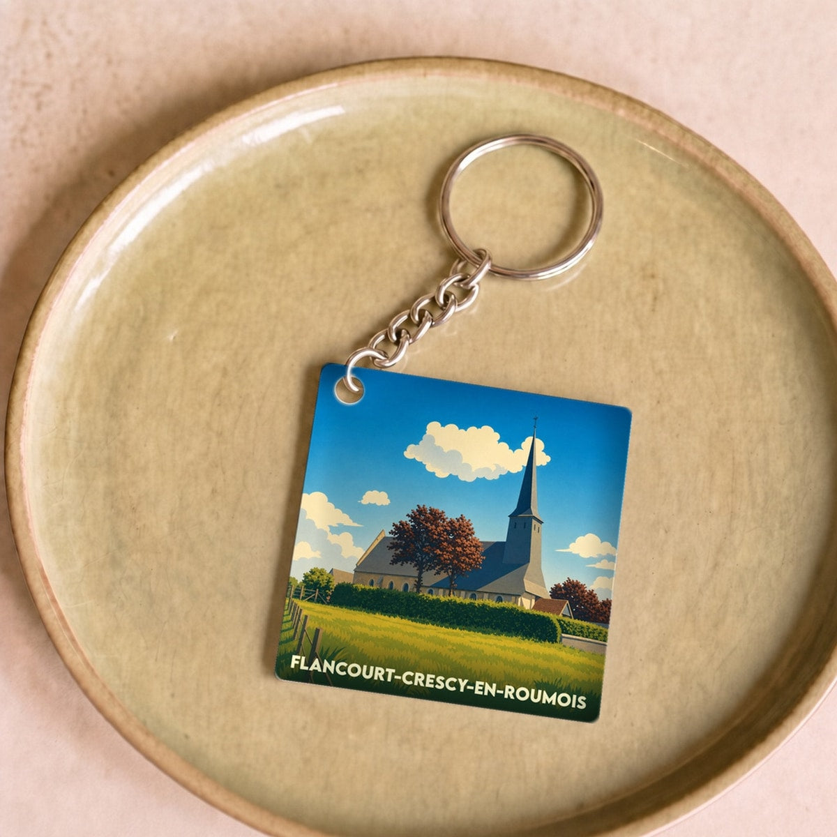 Porte-clés souvenir de Flancourt-Crescy-en-Roumois avec une illustration stylisée de son église.