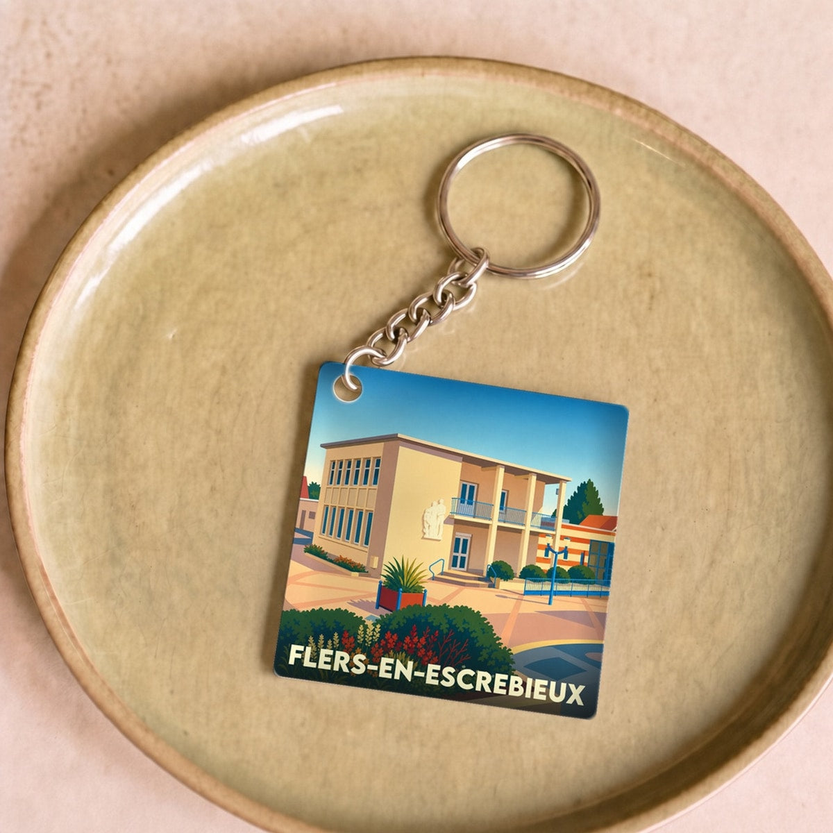 Porte-clés souvenir de la ville de Flers-en-Escrebieux avec une illustration stylisée.