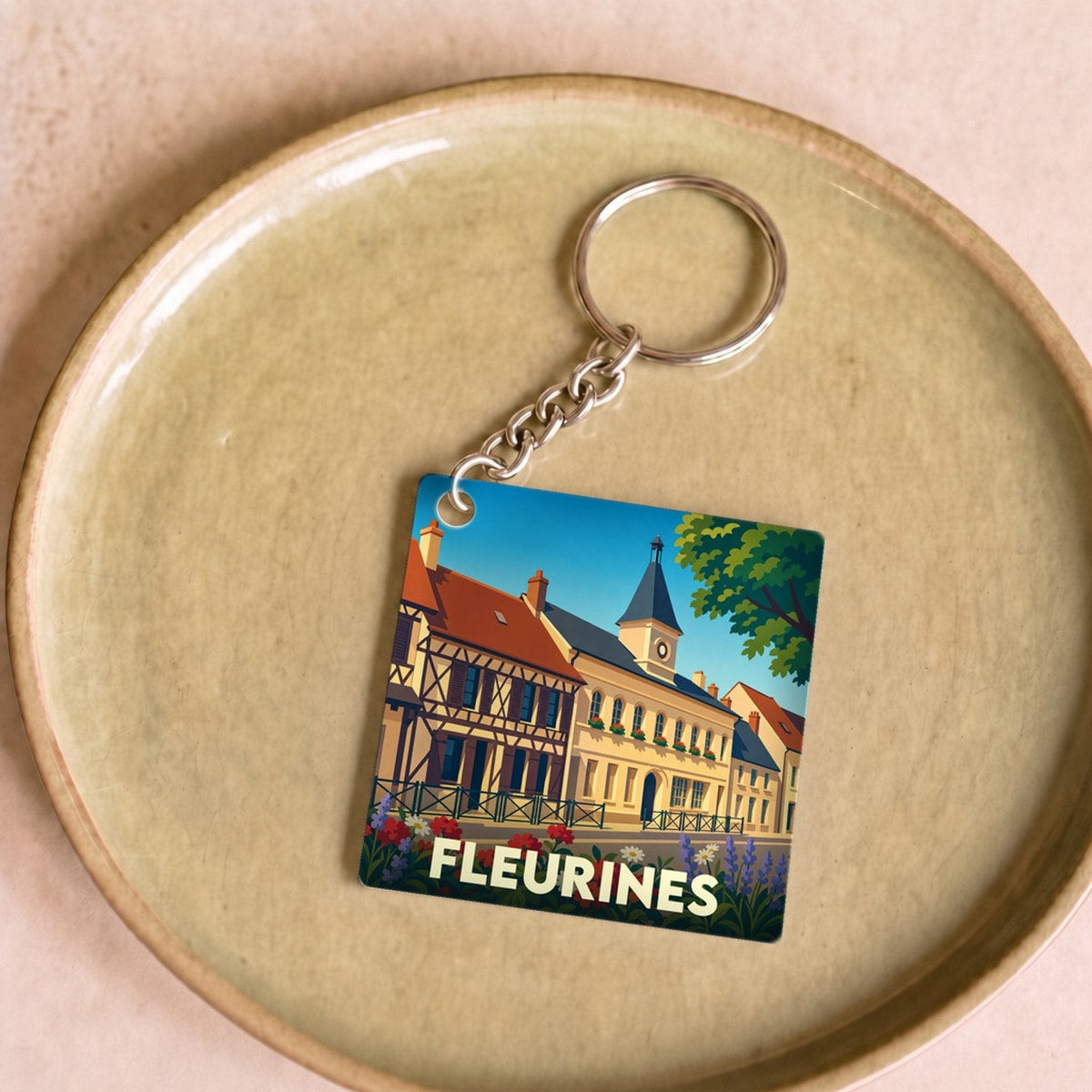 Porte-clés souvenir de la ville de Fleurines avec une illustration colorée et stylisée.