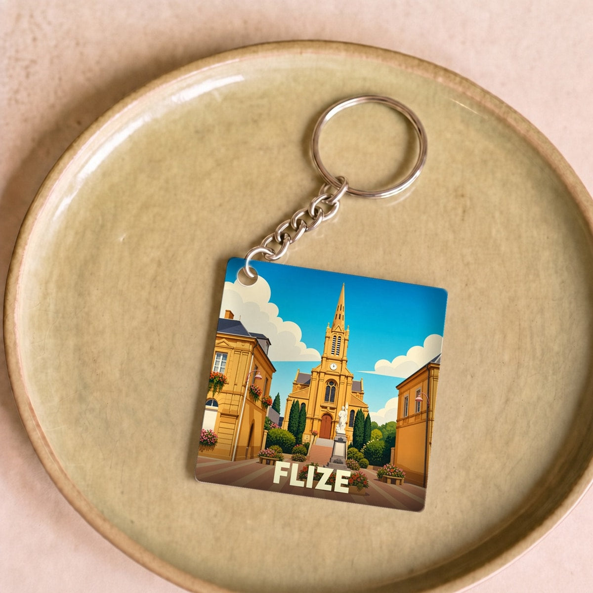 Porte-clés souvenir de la ville de Flize avec une illustration stylisée.