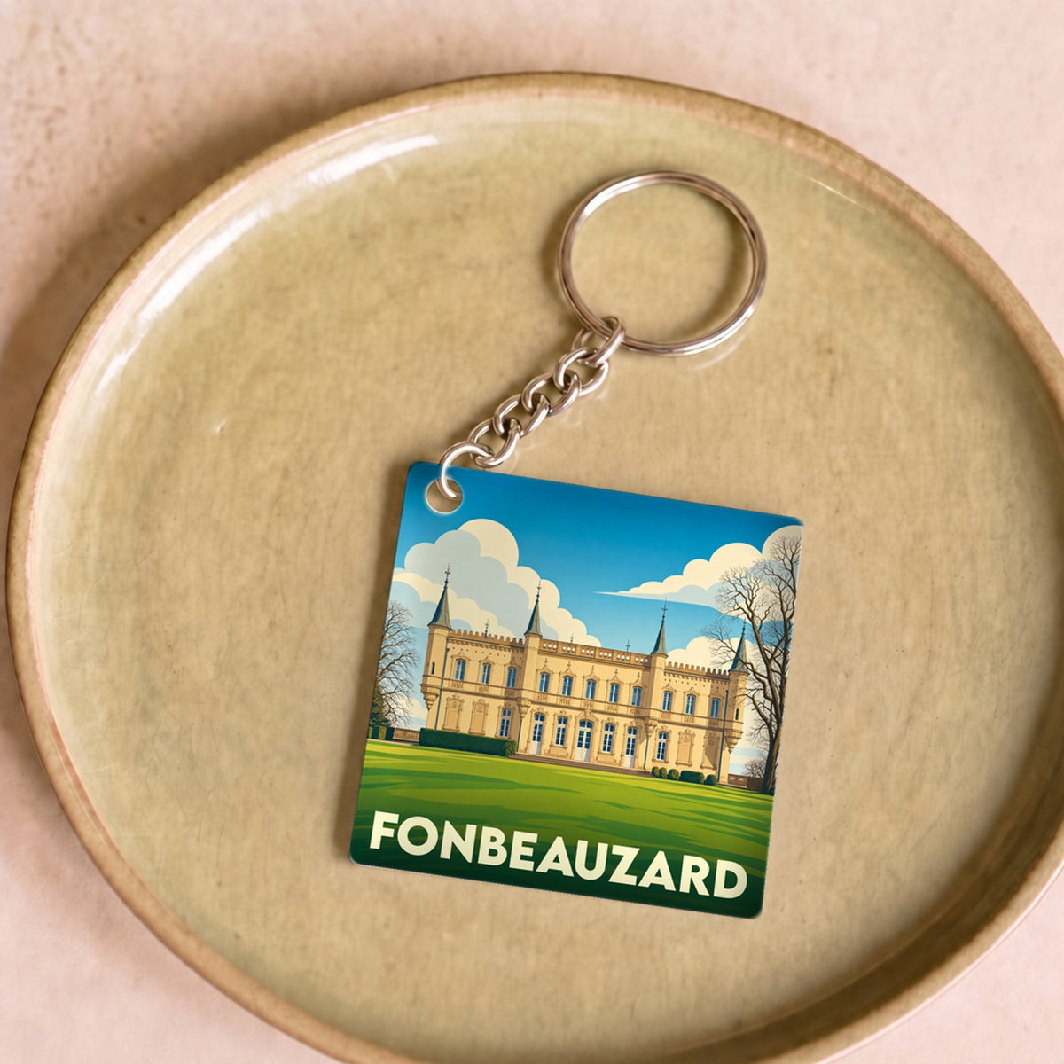 Porte-clés souvenir de la ville de Fonbeauzard avec une illustration stylisée du château local.