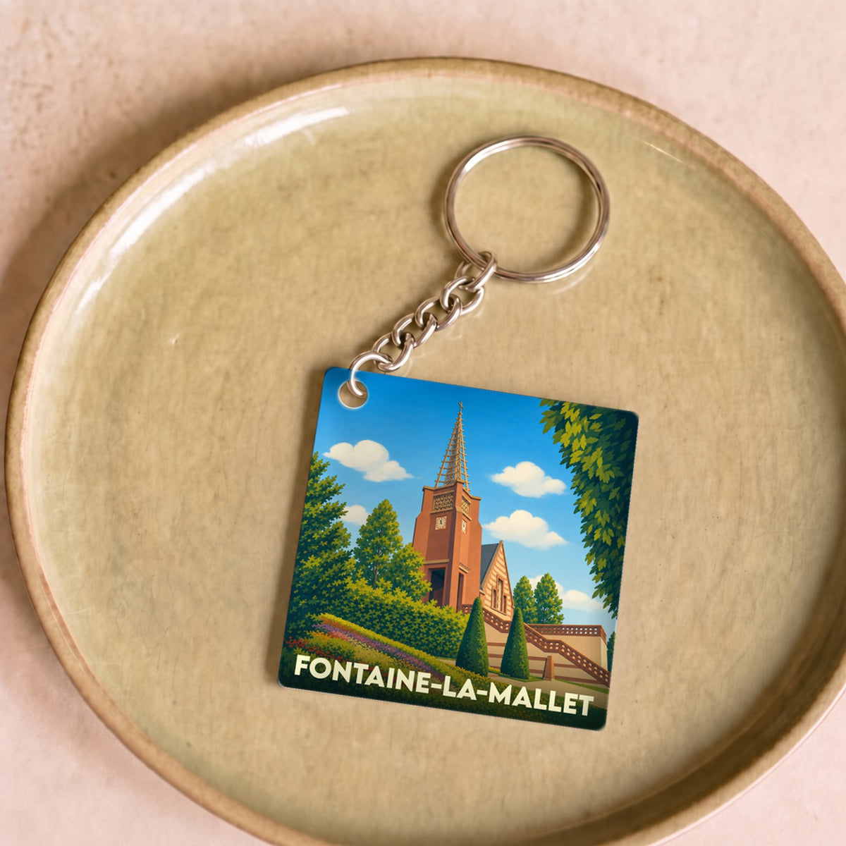 Porte-clés souvenir de la ville de Fontaine-la-Mallet avec une illustration stylisée.