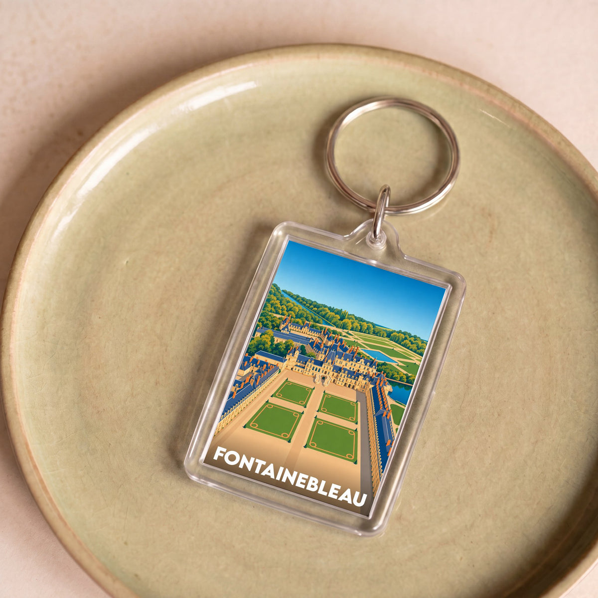 Porte-clés souvenir de la ville de Fontainebleau avec une illustration stylisée de son château.
