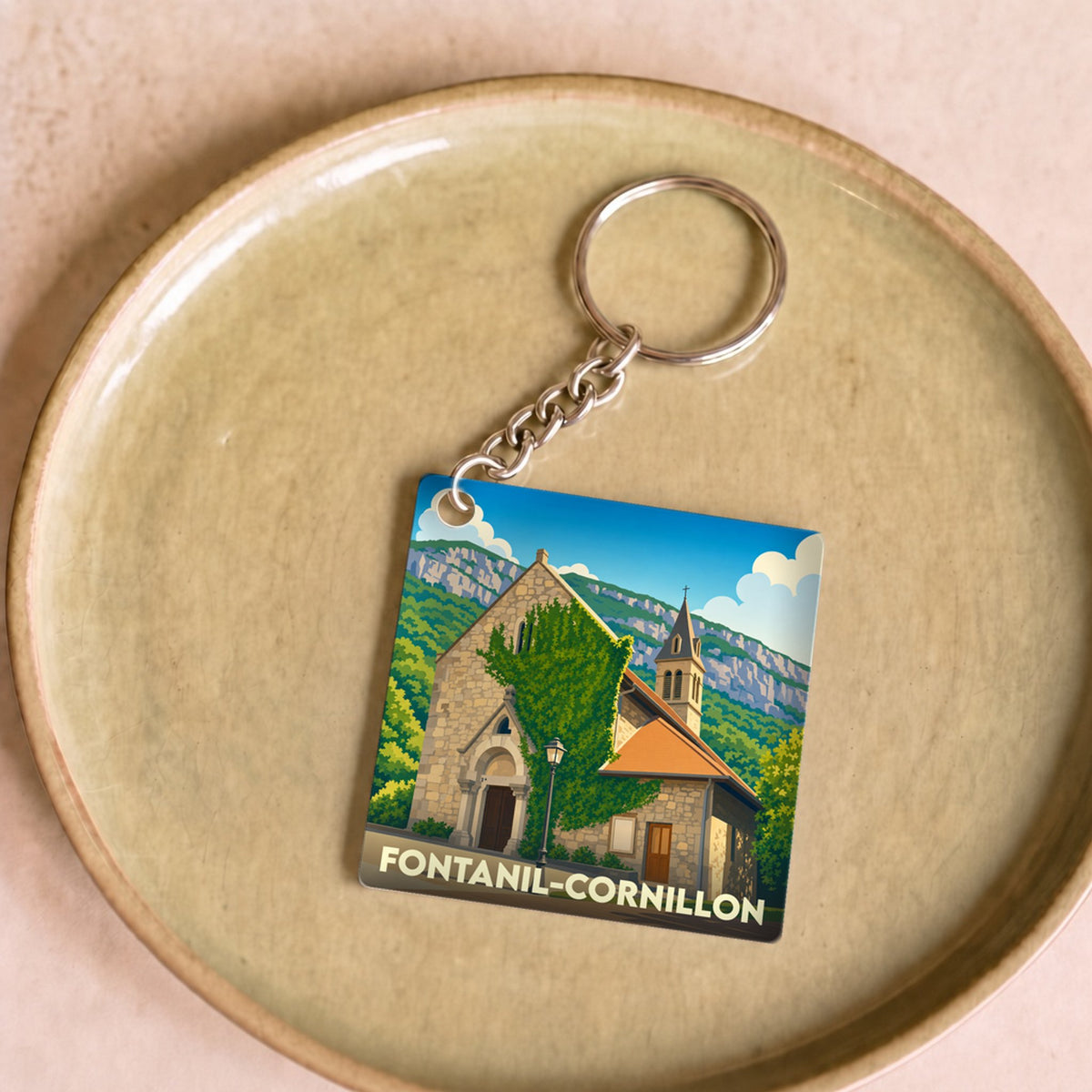 Porte-clés souvenir de la ville de Fontanil-Cornillon avec une illustration stylisée de son église.