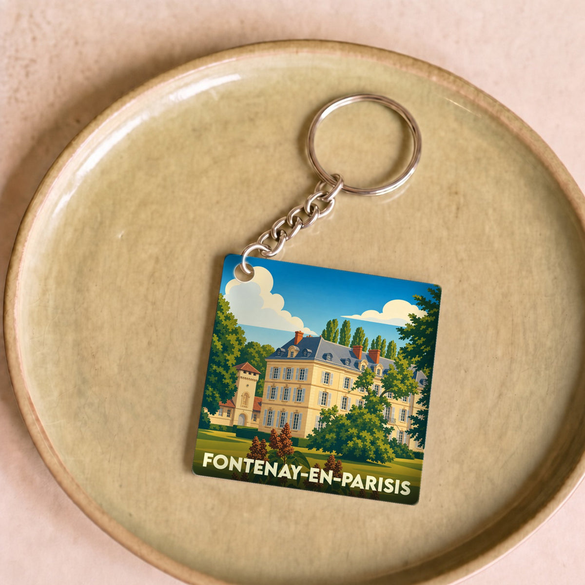 Porte-clés souvenir de la ville de Fontenay-en-Parisis avec une illustration stylisée d'un château.