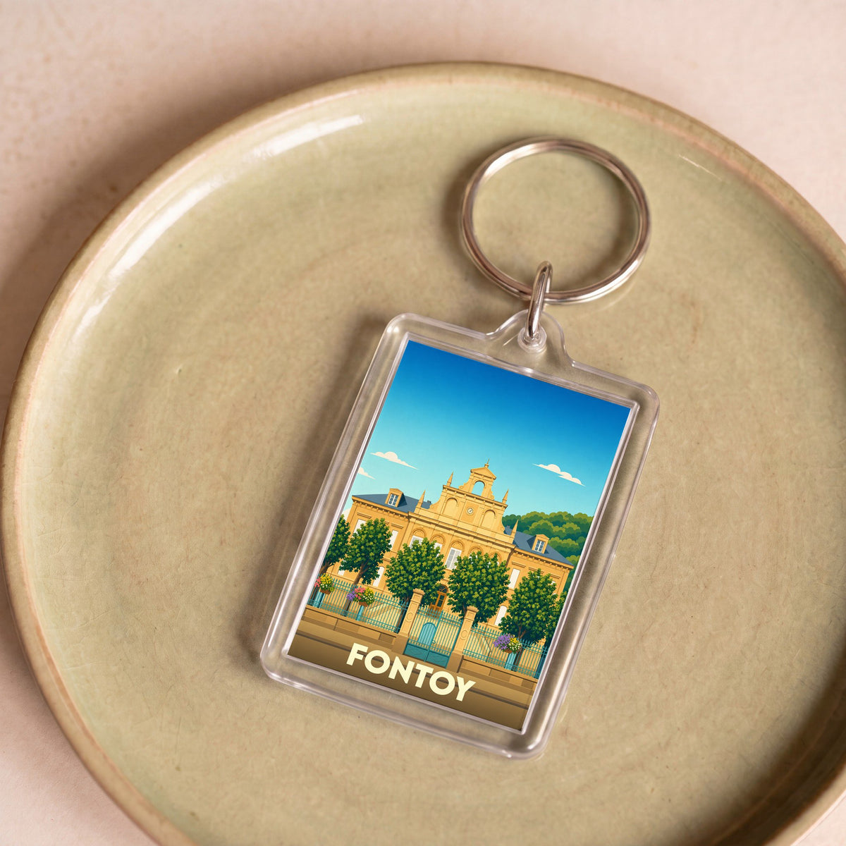 Porte-clés souvenir de la ville de Fontoy avec une illustration stylisée d'un bâtiment historique.