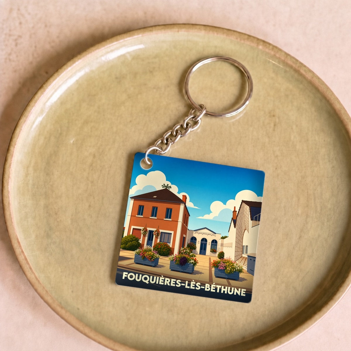 Porte-clés souvenir de la ville de Fouquières-lès-Béthune avec une illustration stylisée.