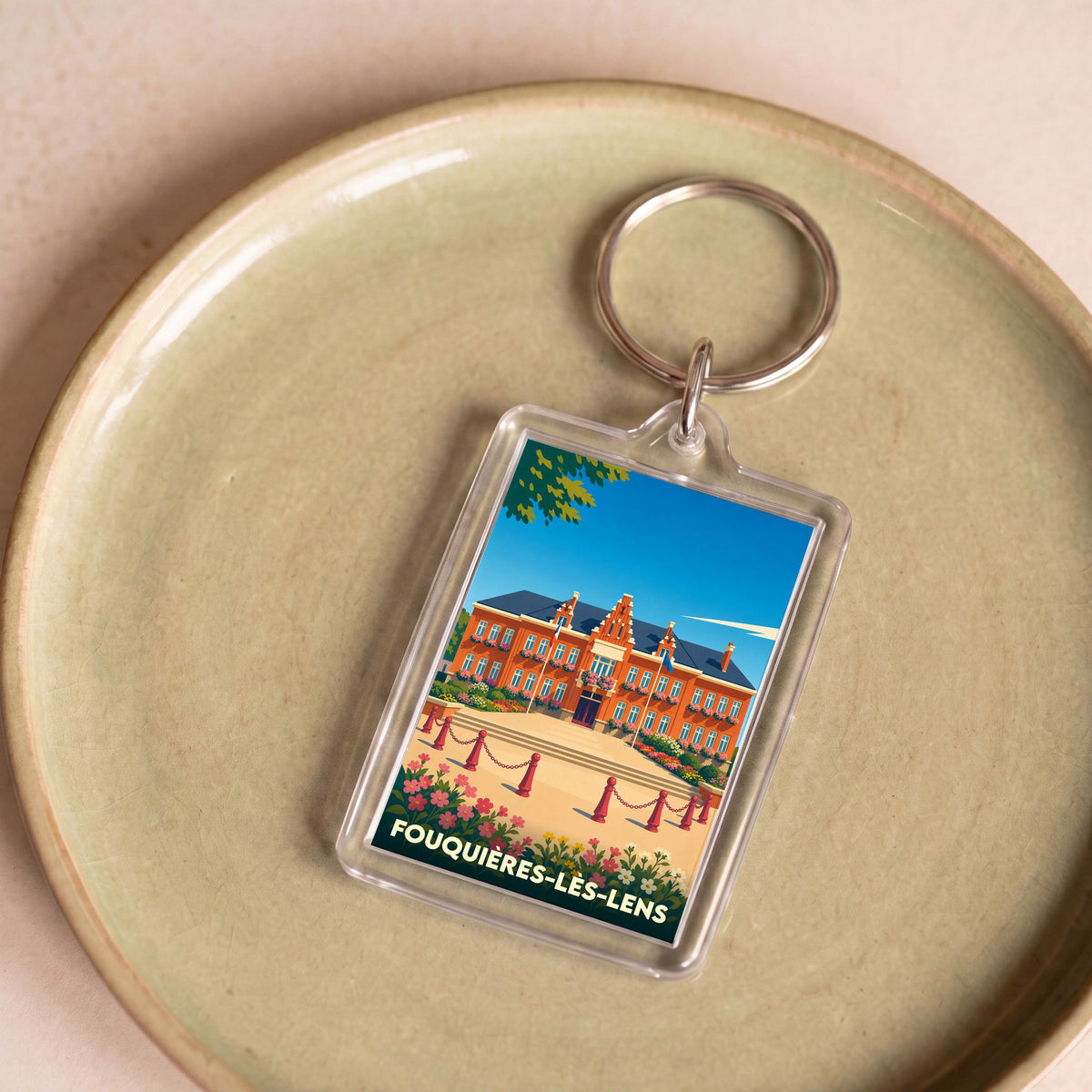 Porte-clés souvenir de la ville de Fouquières-lès-Lens avec une illustration stylisée de son hôtel de ville.