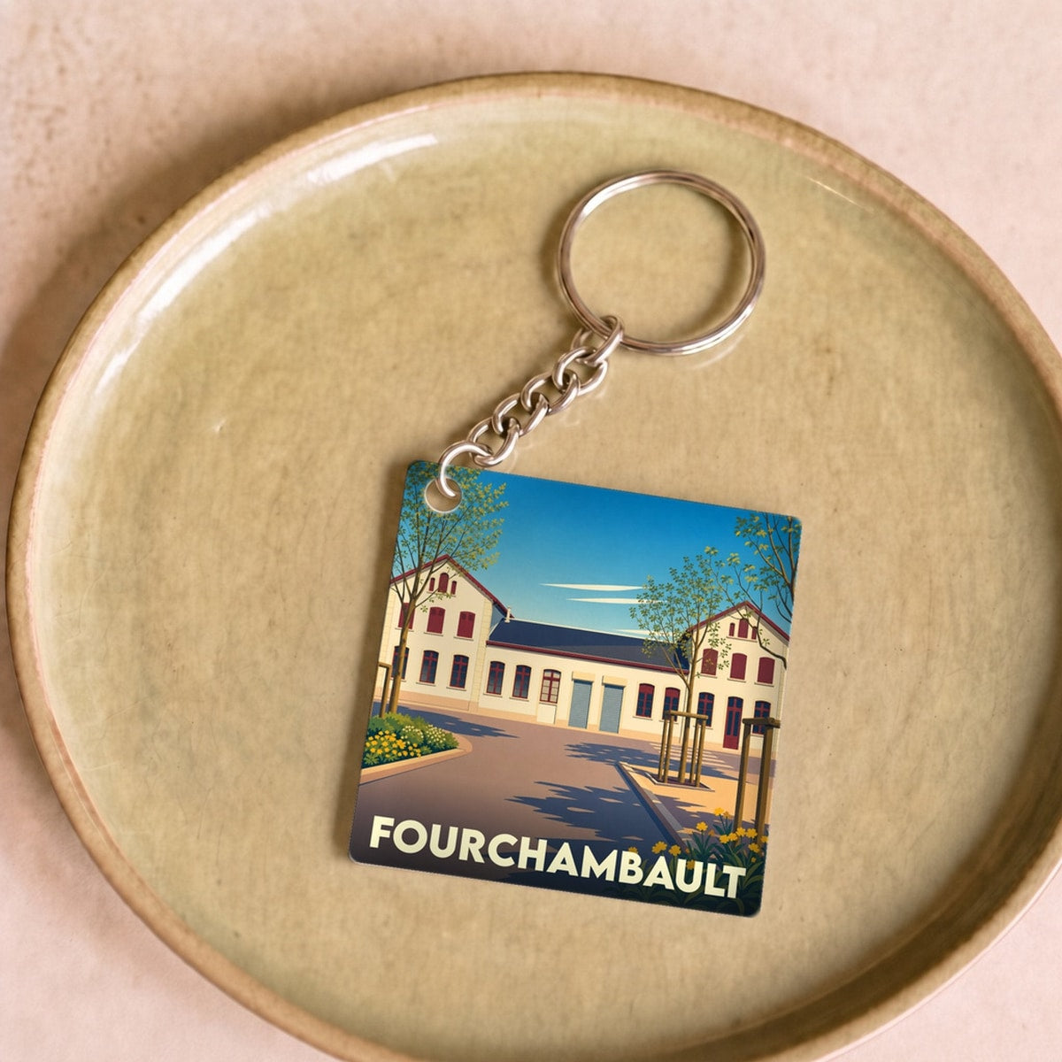 Porte-clés souvenir de la ville de Fourchambault avec une illustration stylisée.