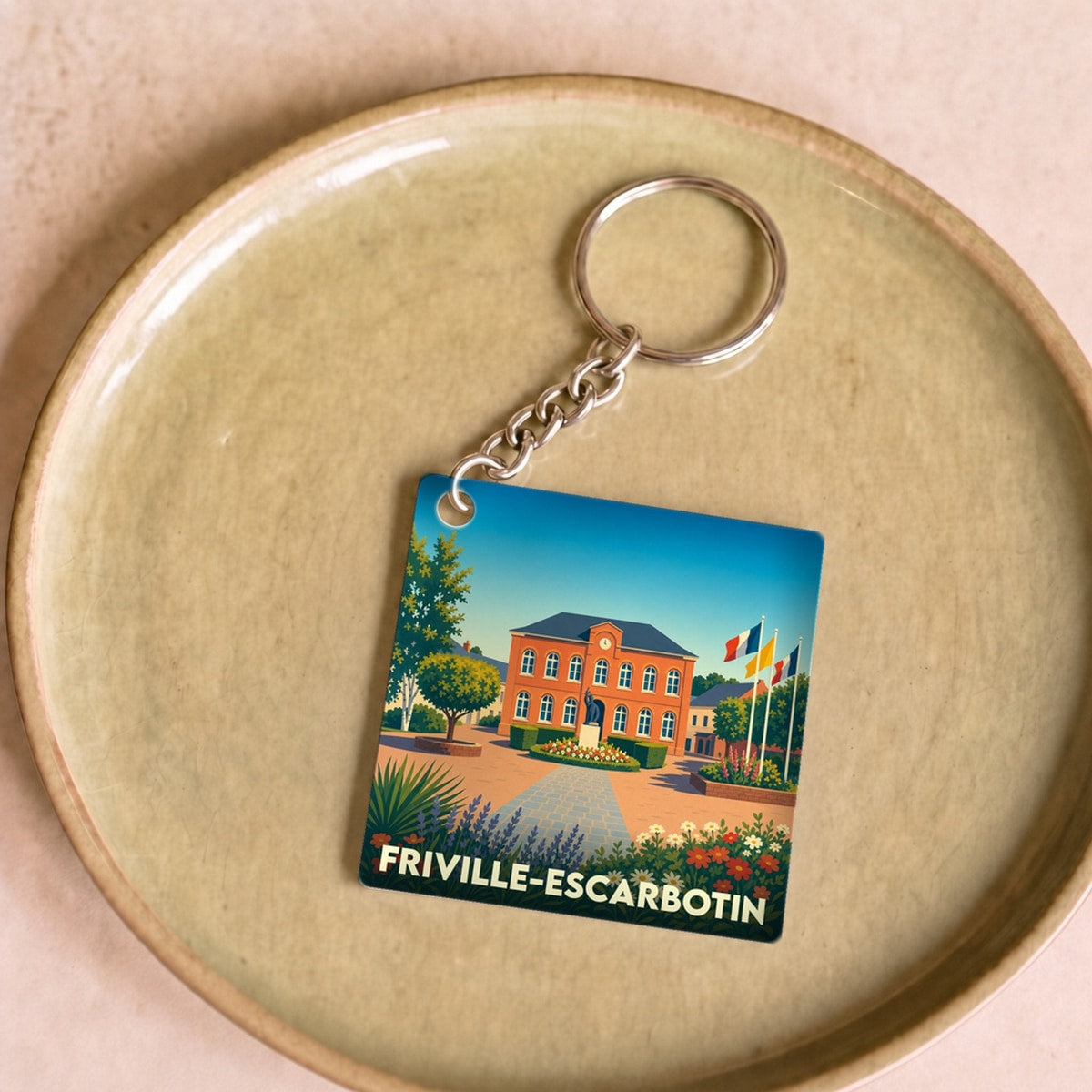 Porte-clés souvenir de la ville de Friville-Escarbotin avec une illustration stylisée.