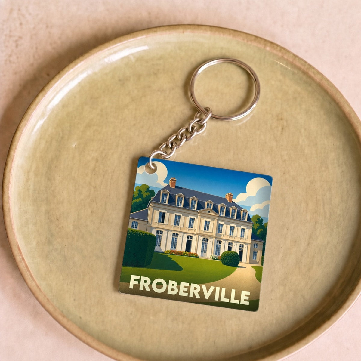Porte-clés souvenir de la ville de Froberville avec une illustration stylisée d'un château.