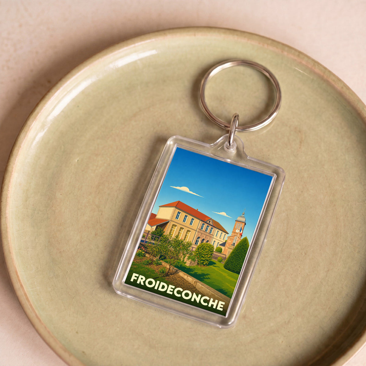 Porte-clés souvenir de la ville de Froideconche avec une illustration stylisée.