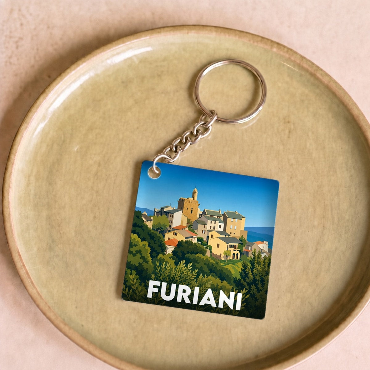Porte-clés souvenir de la ville de Furiani avec une illustration stylisée.