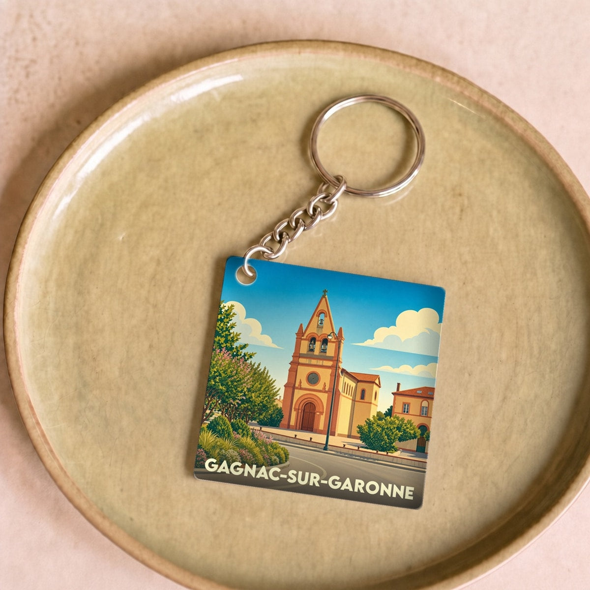 Porte-clés souvenir de la ville de Gagnac-sur-Garonne avec une illustration stylisée de son église.