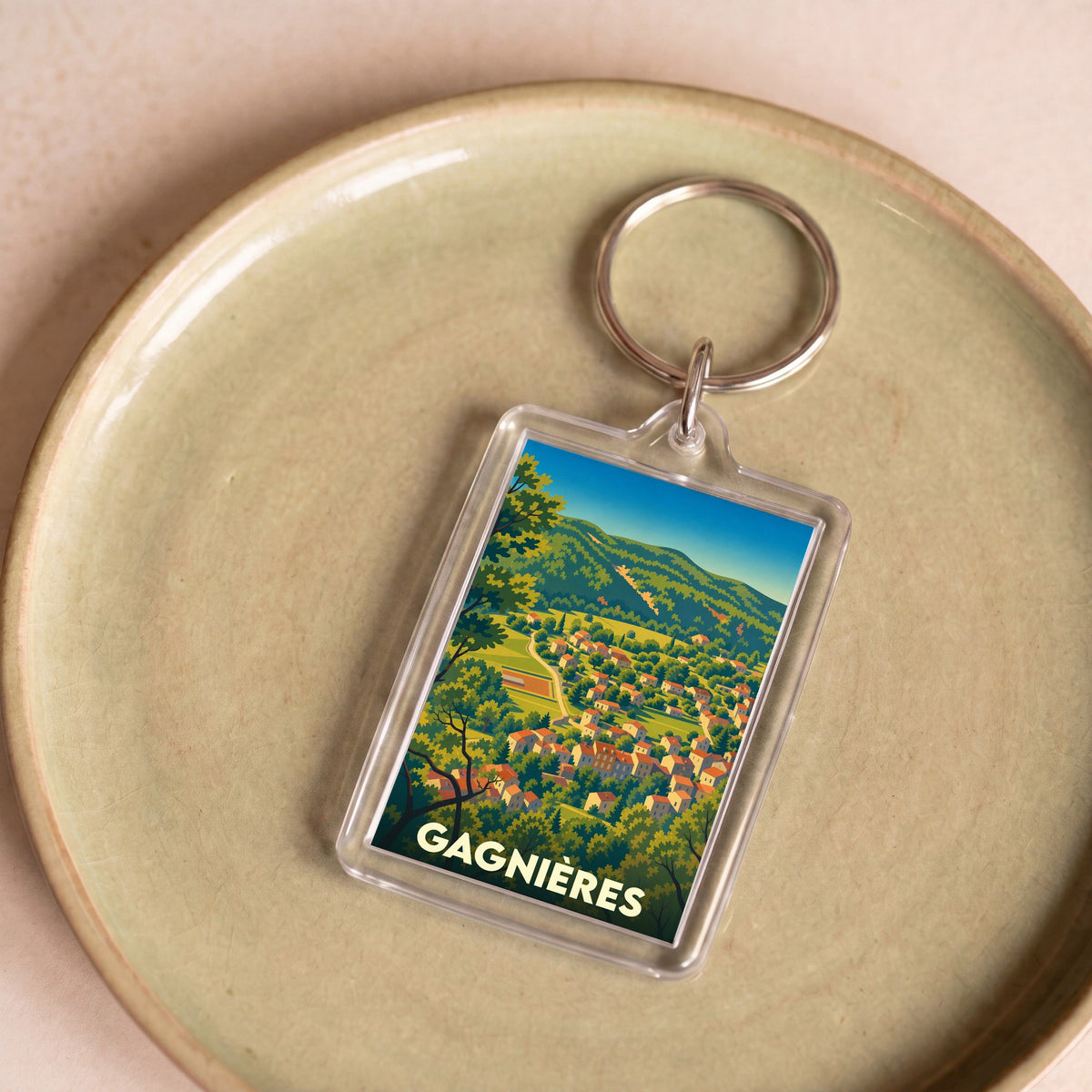 Porte-clés souvenir de la ville de Gagnières avec une illustration stylisée.