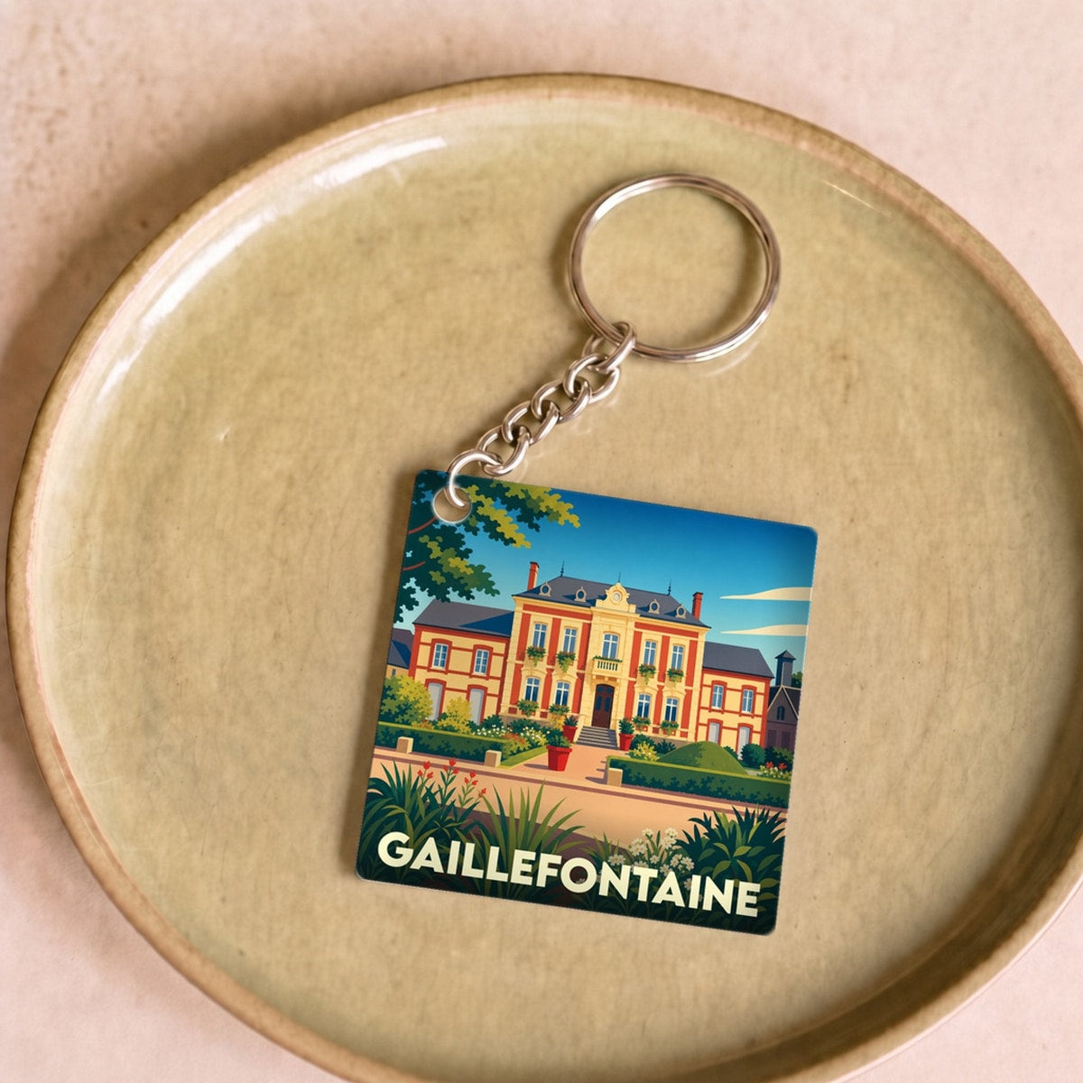 Porte-clés souvenir de la ville de Gaillefontaine avec une illustration stylisée.