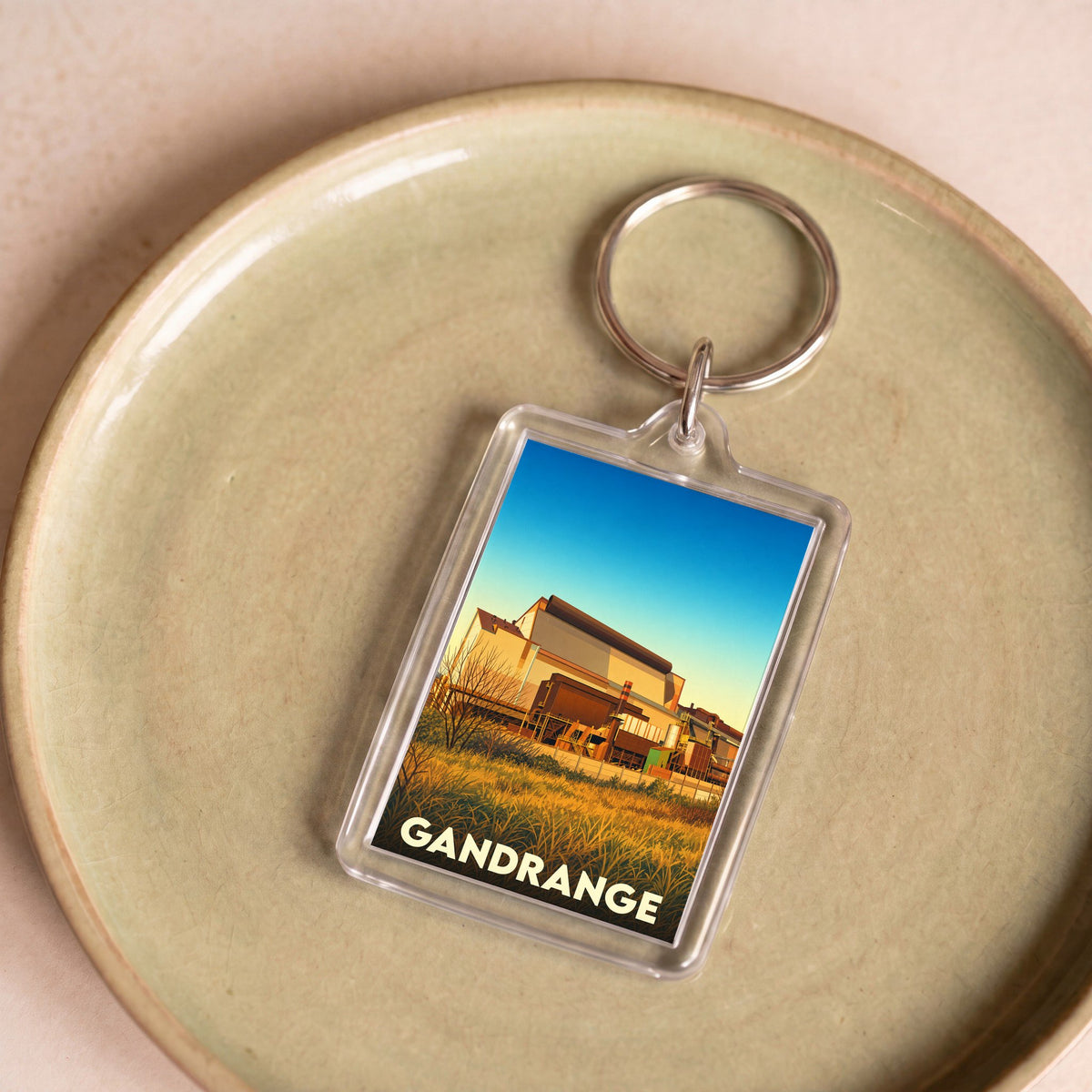 Porte-clés souvenir de la ville de Gandrange avec une illustration stylisée de son patrimoine industriel.