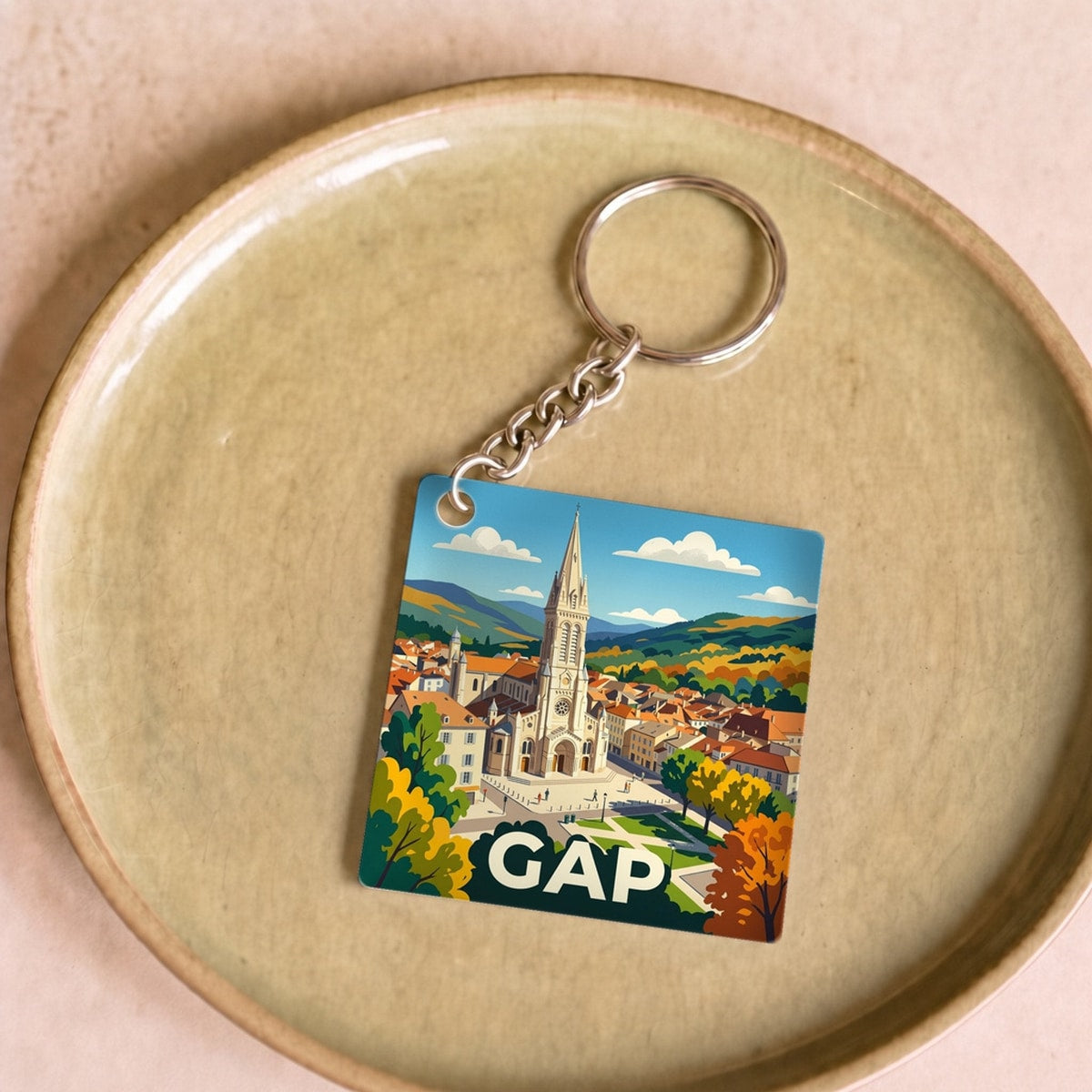 Porte-clés souvenir de la ville de Gap avec une illustration stylisée.