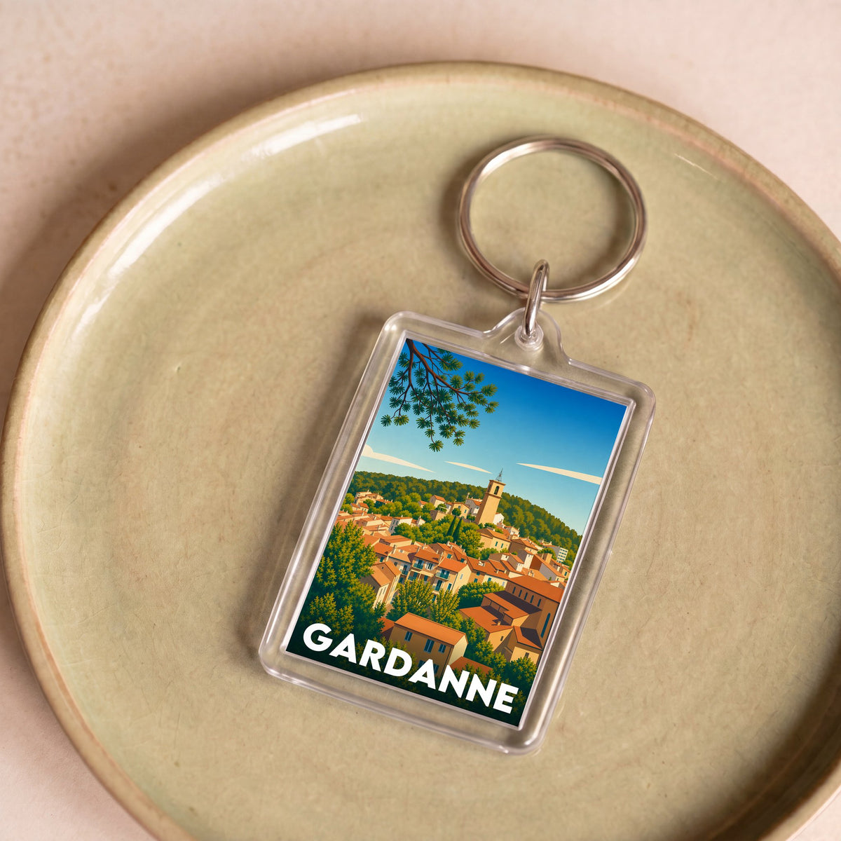 Porte-clés souvenir de la ville de Gardanne avec une illustration stylisée.
