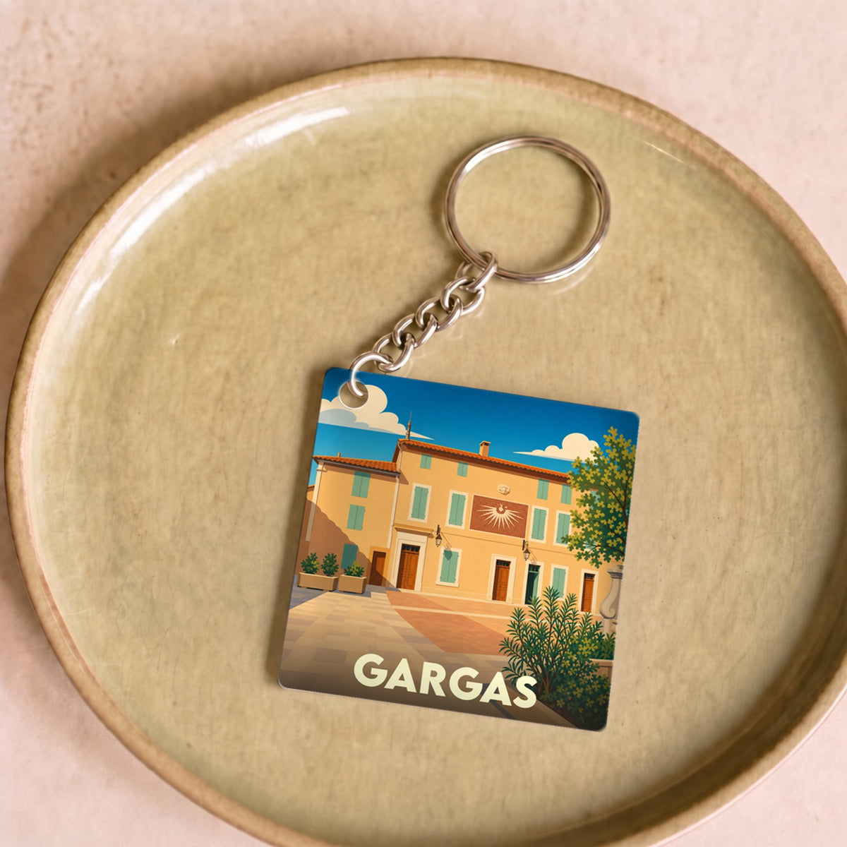 Porte-clés souvenir de la ville de Gargas avec une illustration stylisée.