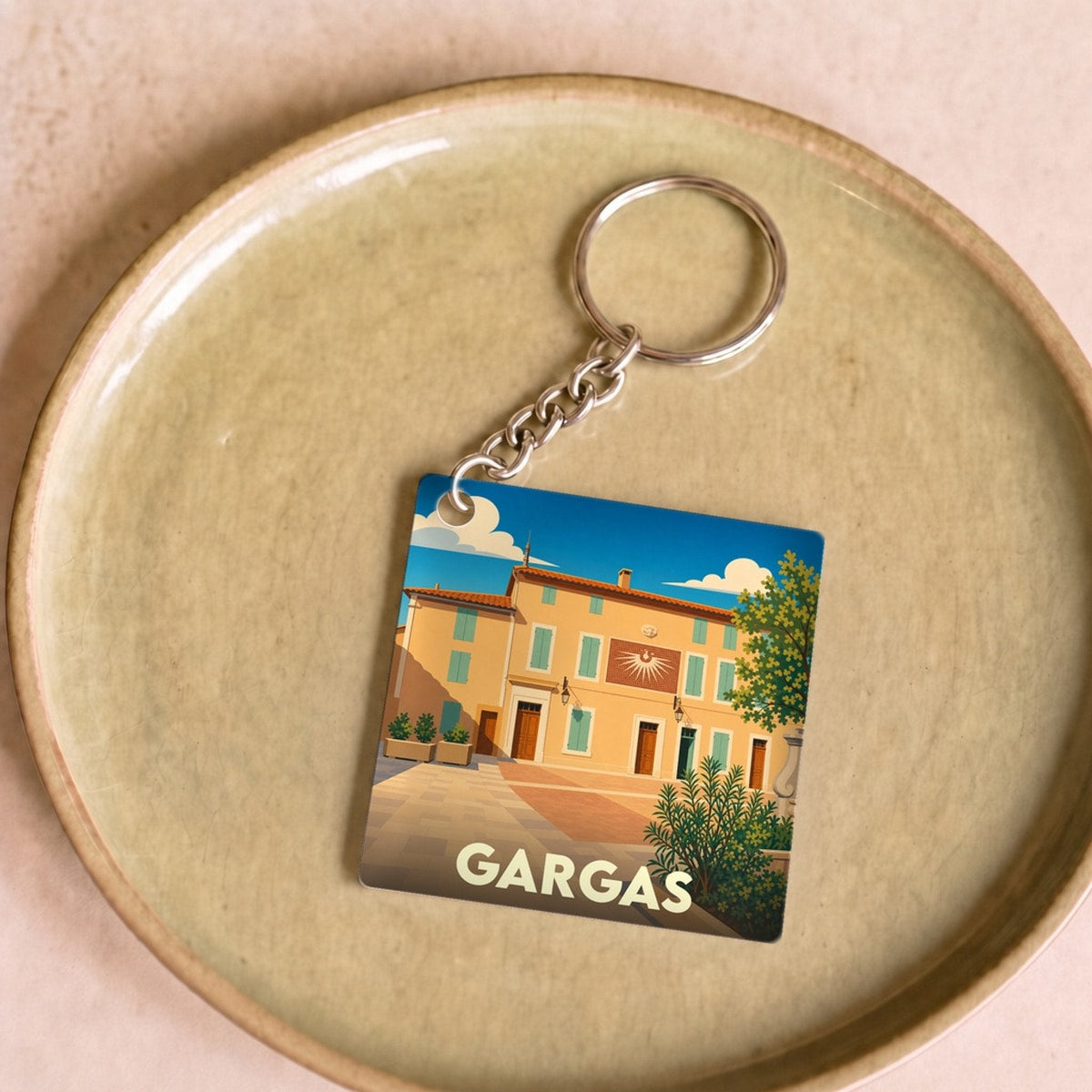 Porte-clés souvenir de la ville de Gargas avec une illustration stylisée.