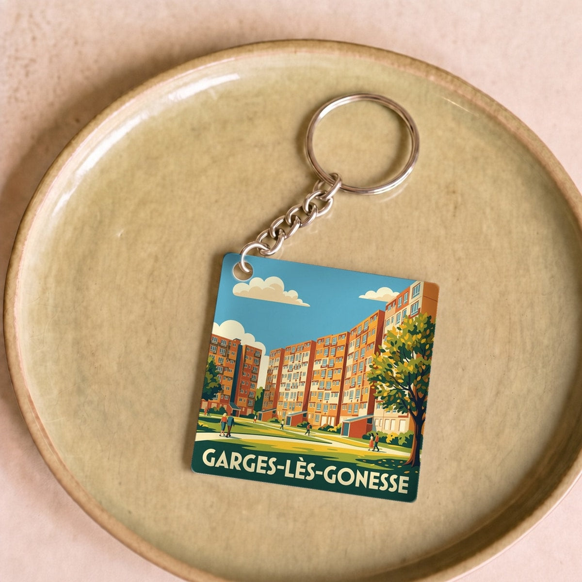 Porte-clés souvenir de la ville de Garges-lès-Gonesse avec une illustration stylisée.