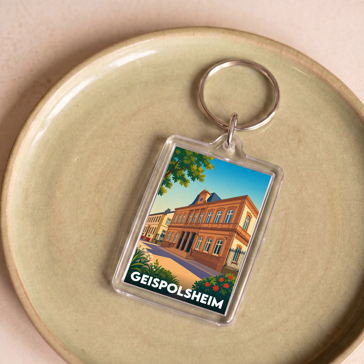 Porte-clés souvenir de la ville de Geispolsheim avec une illustration stylisée.