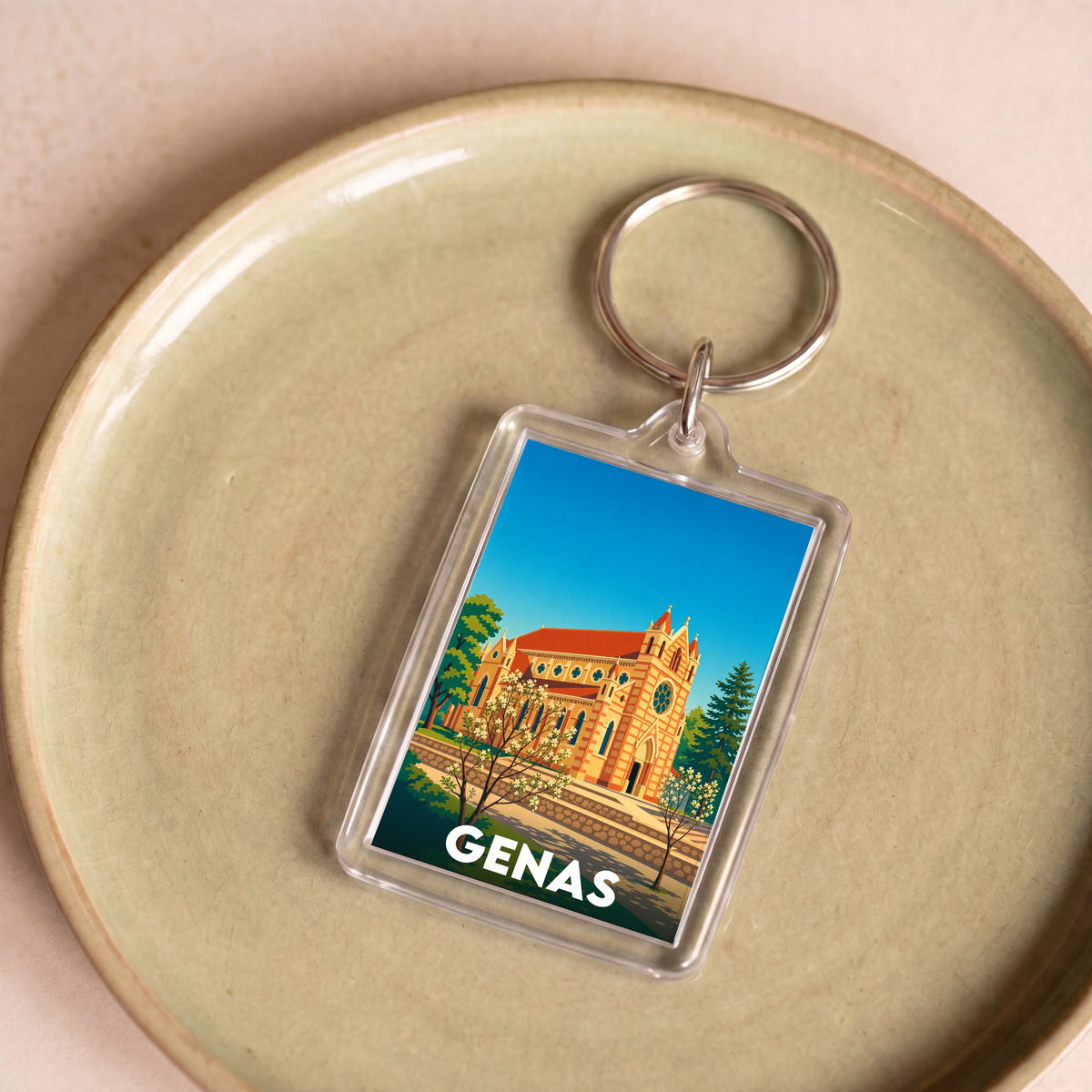 Porte-clés souvenir de la ville de Genas avec une illustration stylisée.