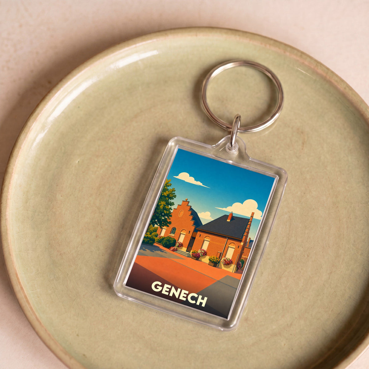 Porte-clés souvenir de la ville de Genech avec une illustration stylisée d'une maison traditionnelle.