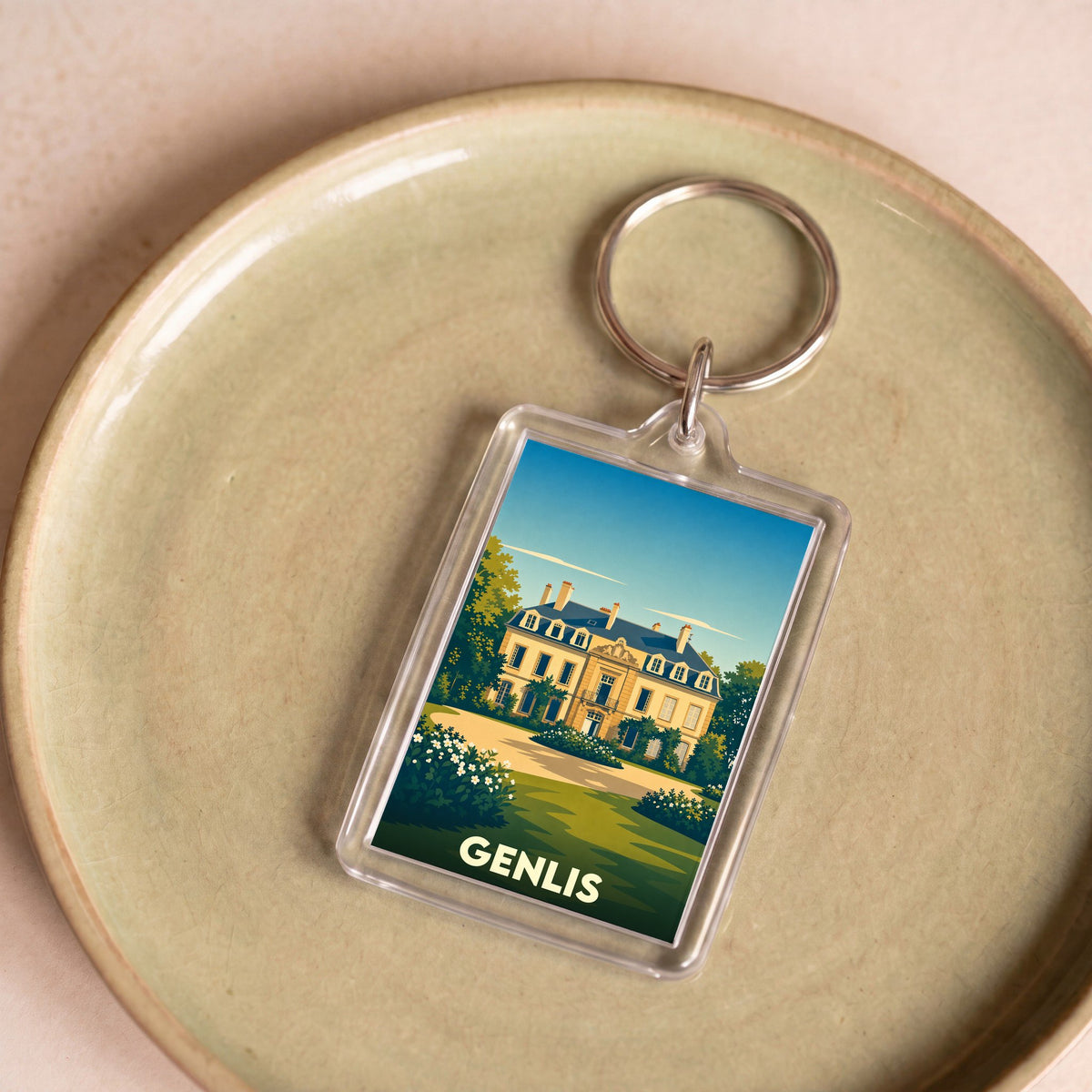 Porte-clés souvenir de la ville de Genlis avec une illustration stylisée d'un château.