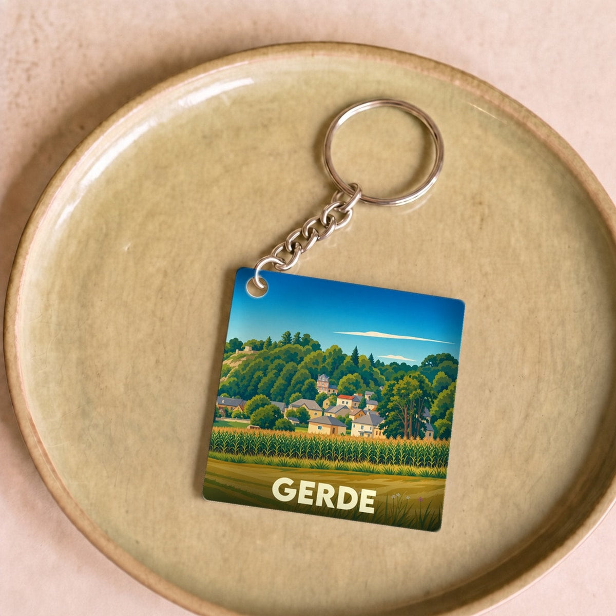 Porte-clés souvenir de la ville de Gerde avec une illustration stylisée.