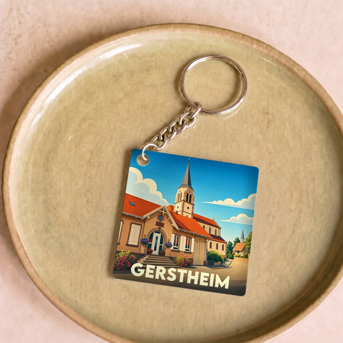 Porte-clés souvenir de la ville de Gerstheim avec une illustration stylisée.