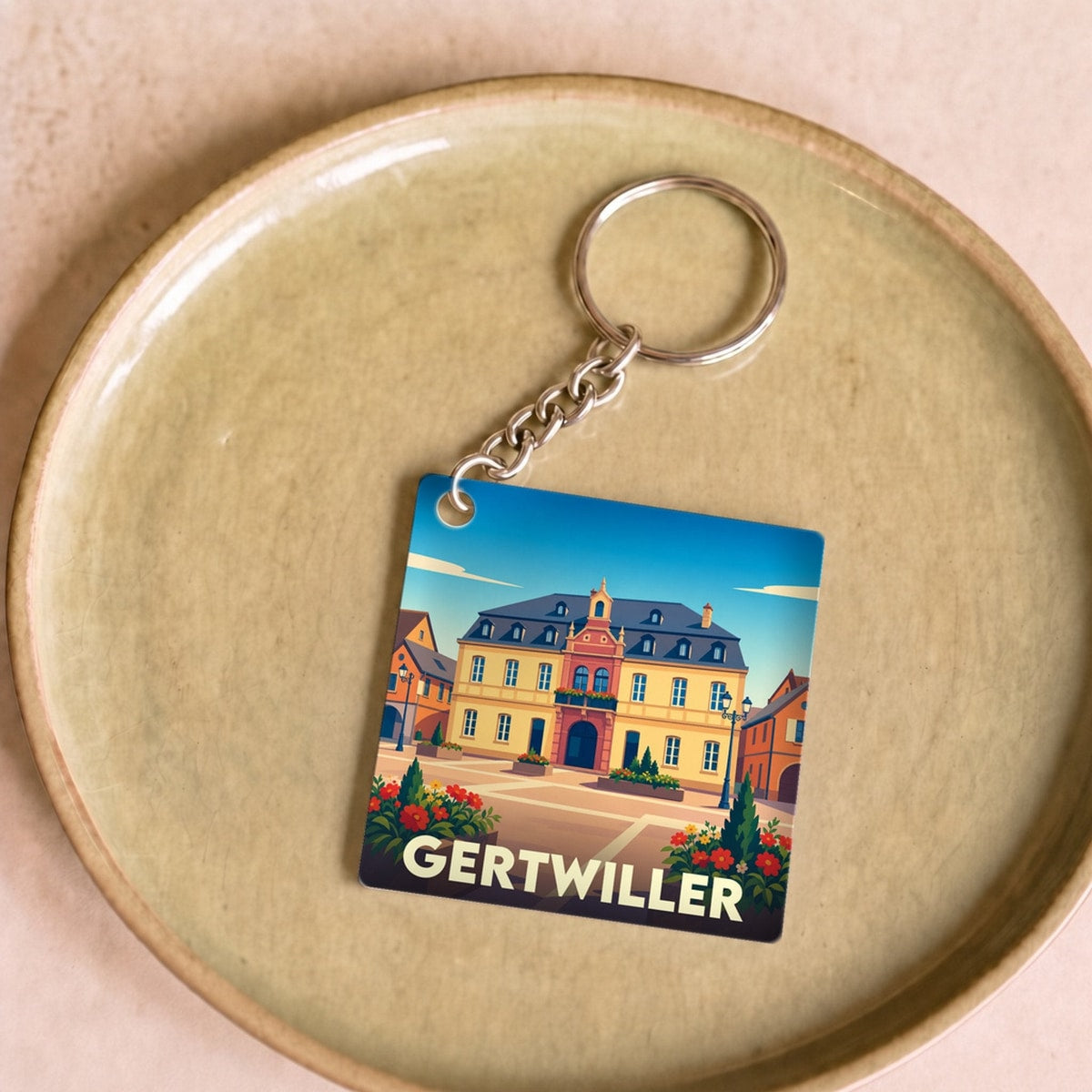Porte-clés souvenir de la ville de Gertwiller avec une illustration stylisée.