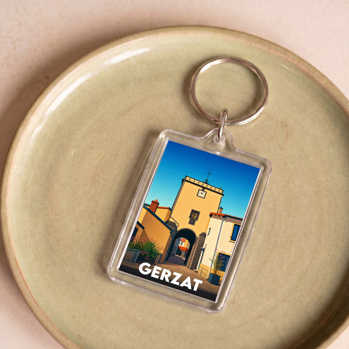 Porte-clés souvenir de la ville de Gerzat avec une illustration stylisée.