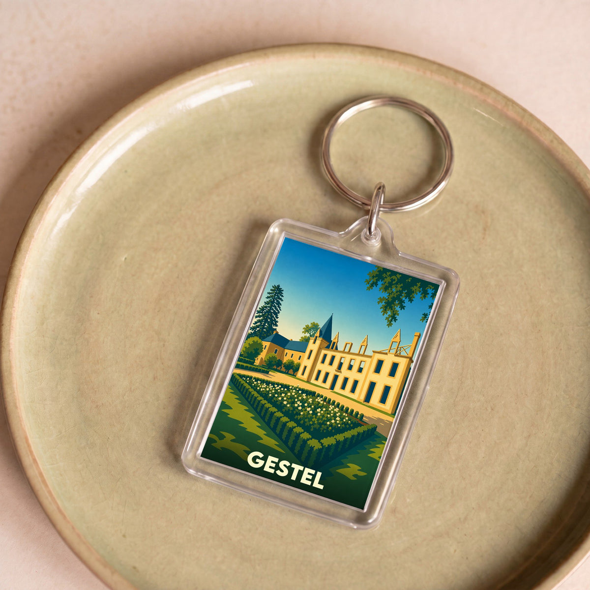 Porte-clés souvenir de la ville de Gestel avec une illustration stylisée de son château.