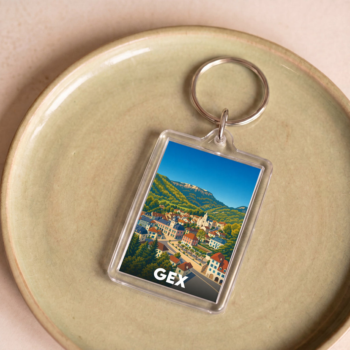 Porte-clés souvenir de la ville de Gex avec une illustration stylisée.