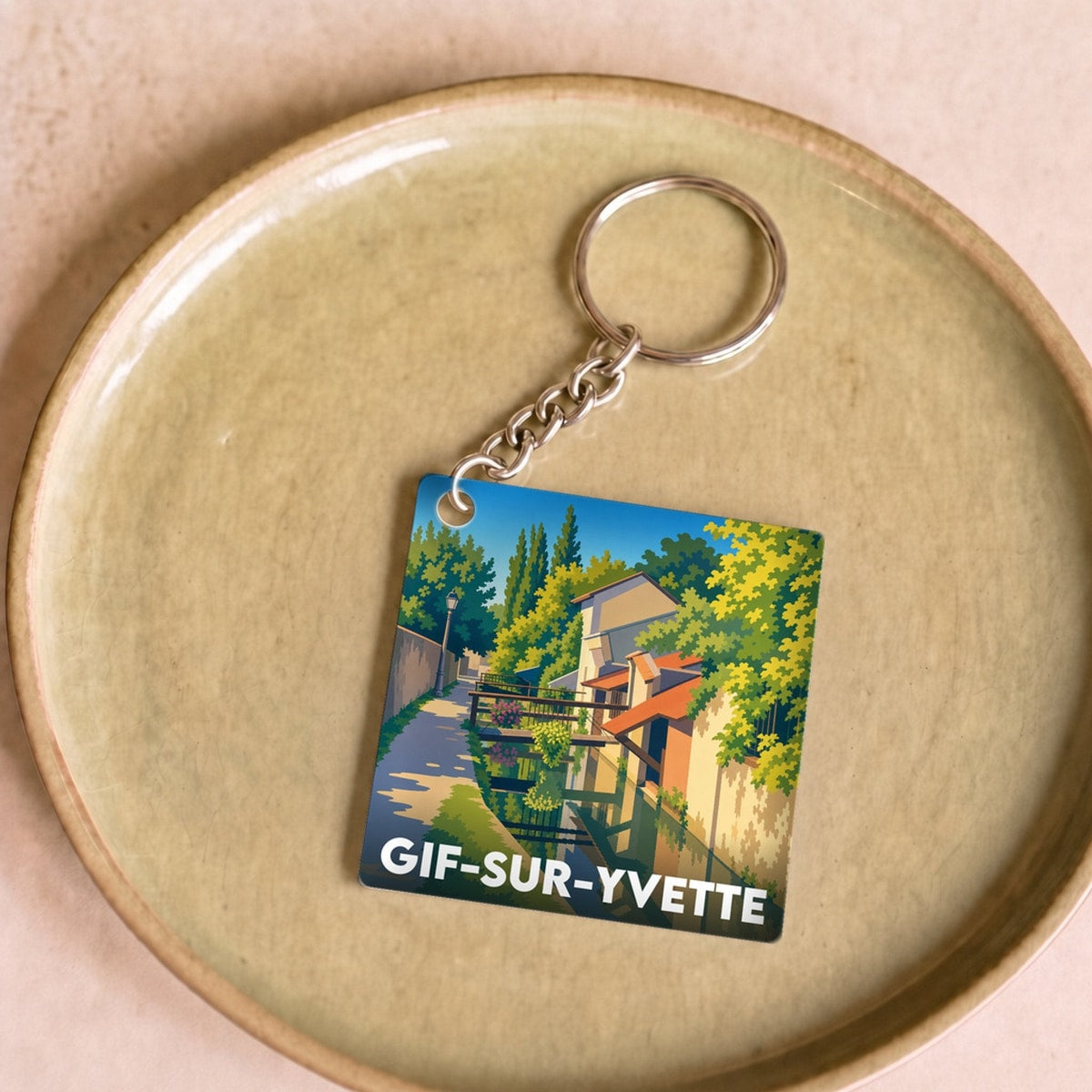 Porte-clés souvenir de la ville de Gif-sur-Yvette avec une illustration stylisée.