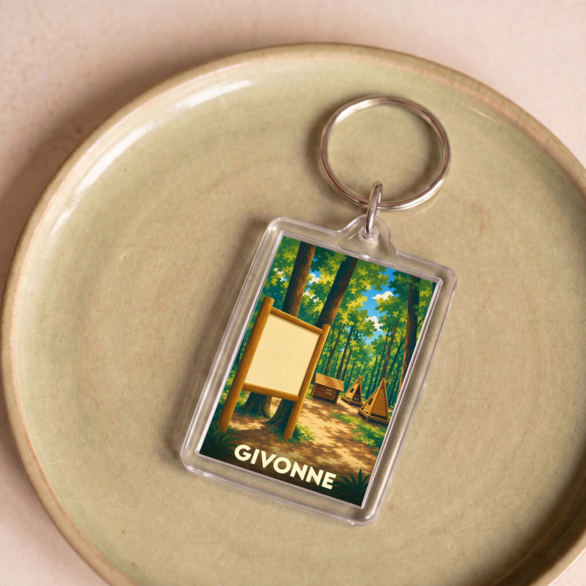 Porte-clés souvenir de la ville de Givonne avec une illustration stylisée d'une forêt.