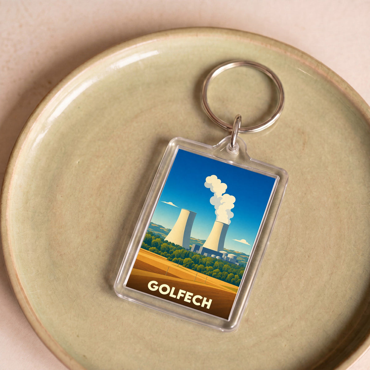 Porte-clés souvenir de la ville de Golfech avec une illustration stylisée de sa centrale nucléaire.