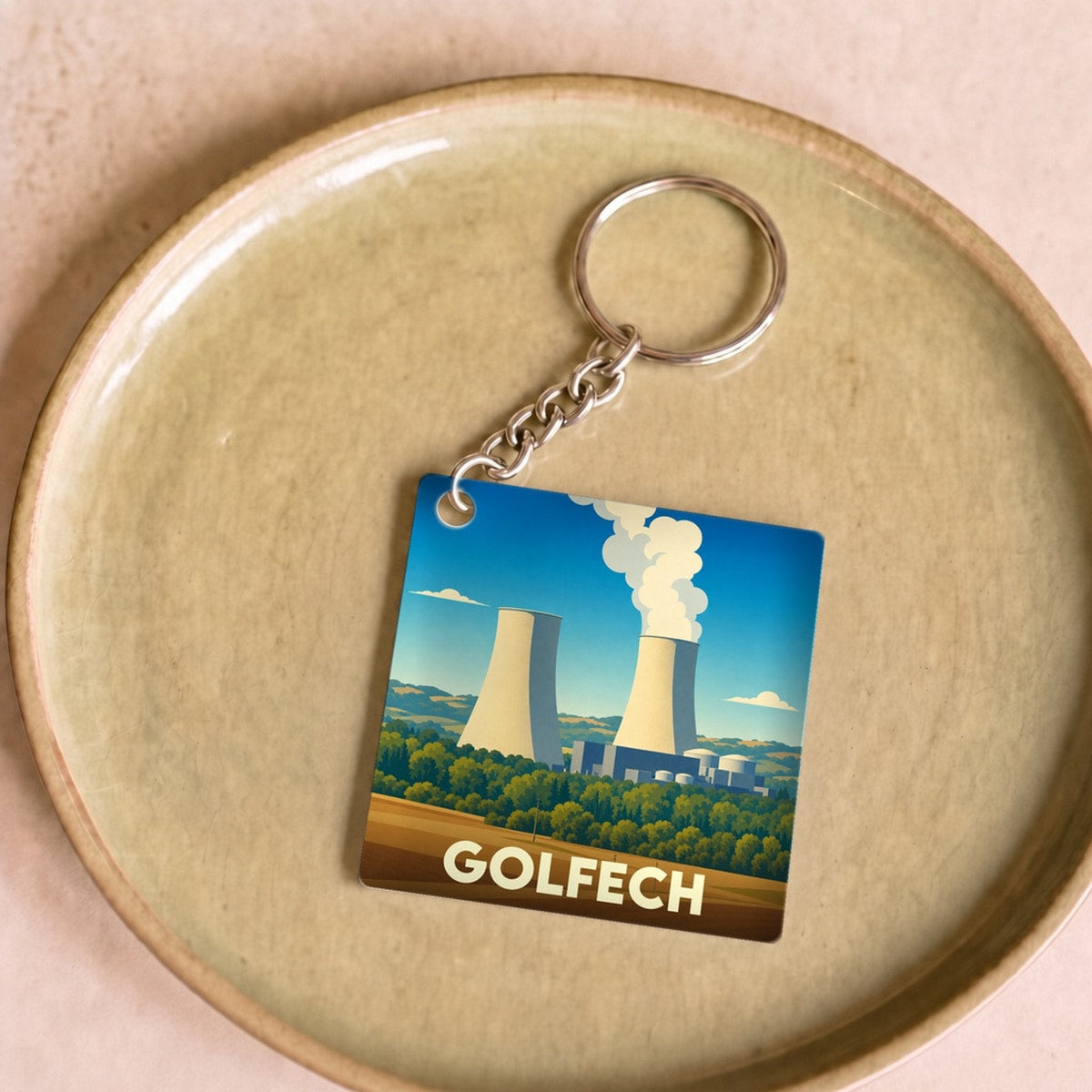 Porte-clés souvenir de la ville de Golfech avec une illustration stylisée de sa centrale nucléaire.