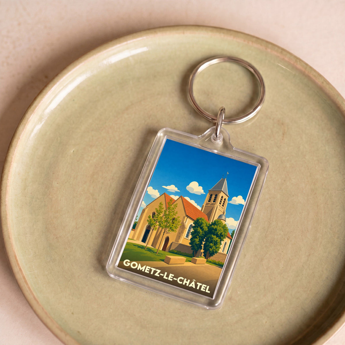 Porte-clés souvenir de la ville de Gometz-le-Châtel avec une illustration stylisée de son église.