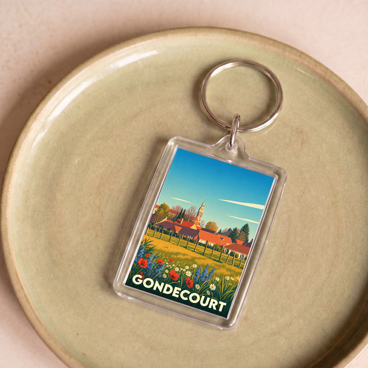 Porte-clés souvenir de la ville de Gondecourt avec une illustration stylisée de son paysage urbain et champêtre.